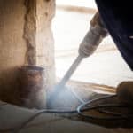 Contractor retrofitting pipe - feature image for blog post from Victaulic with mechanical retrofitting best practices